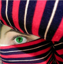 eye hidden behind a striped sweater